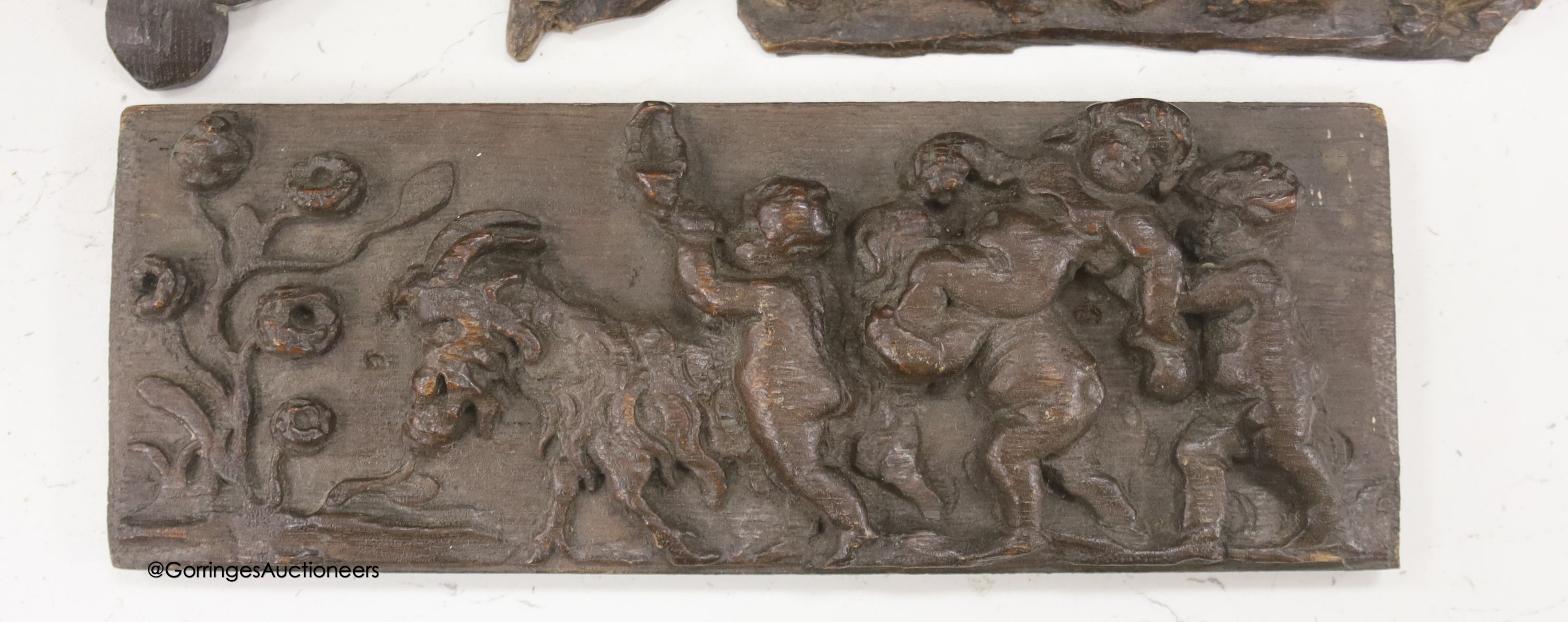 Seven 17th century or later carved oak fragments including a pair of lion masks